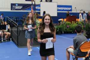 student walking with certificate